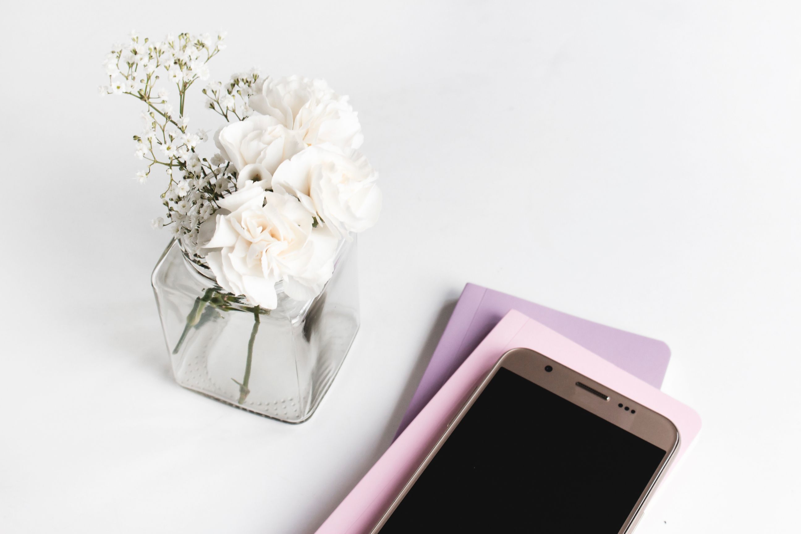 cell phone and flowers on home office desk