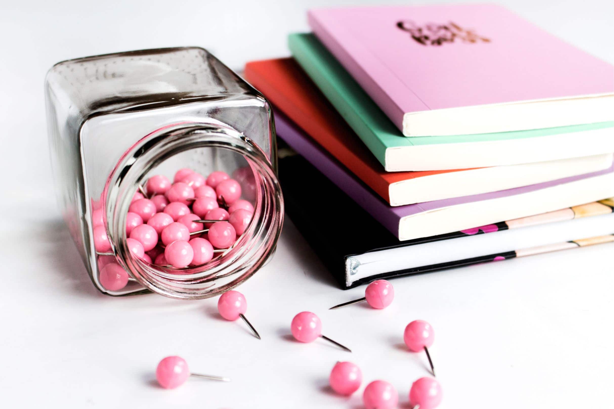 notebooks and pink push pins in home office