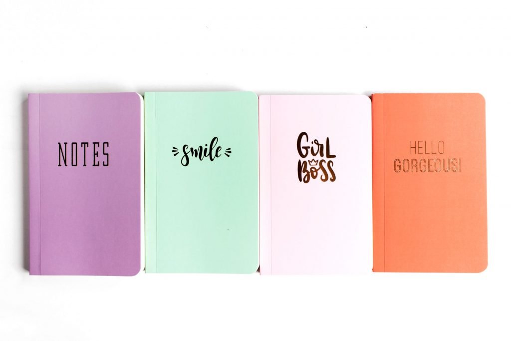 row of styled notebooks in bright colors
