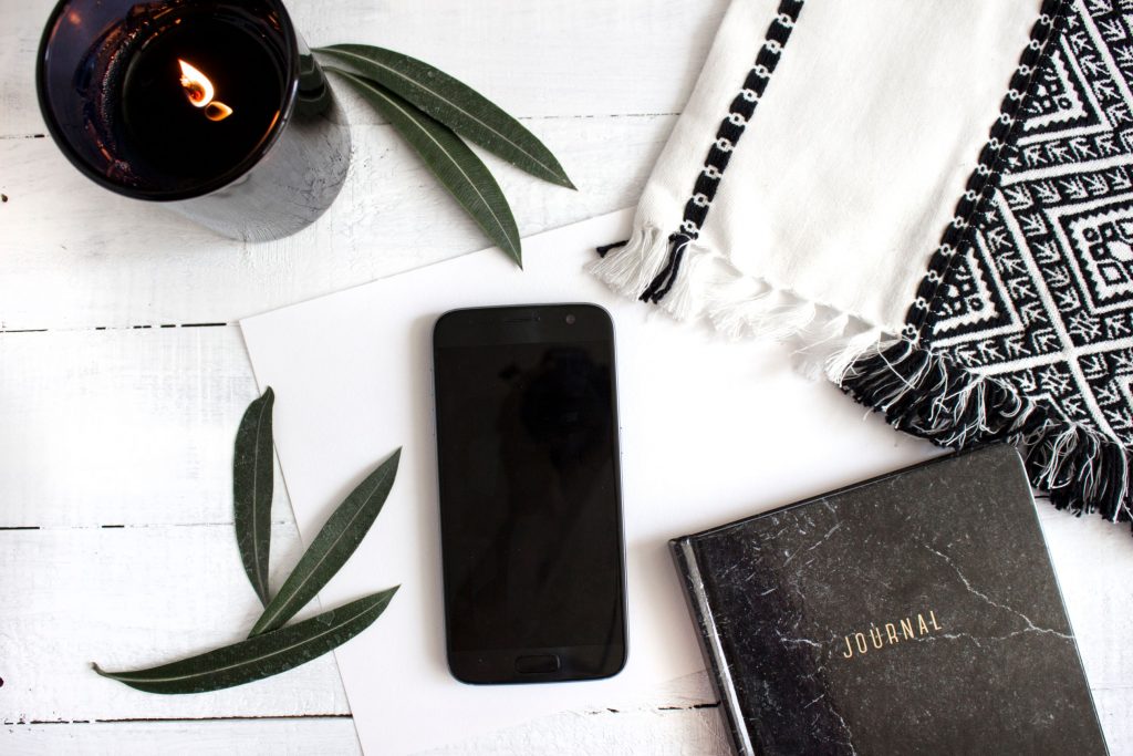 cell phone and journal home office flatlay