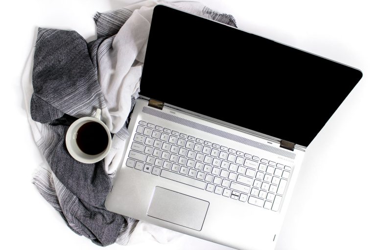 computer and coffee for virtual assistant website design