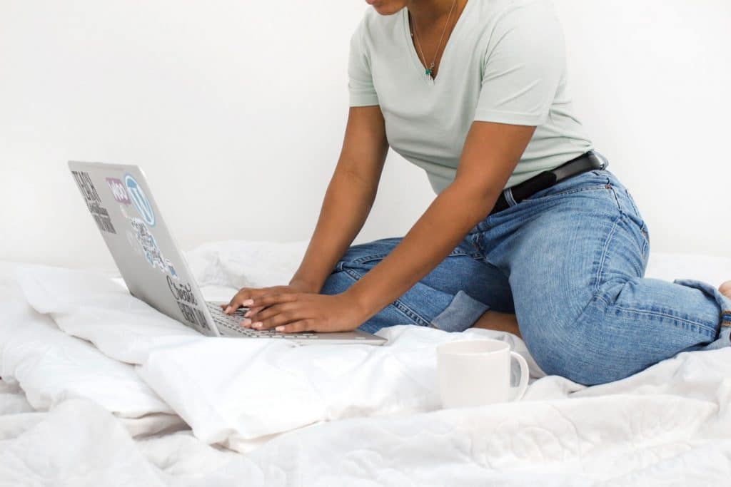 working from home on laptop in bed