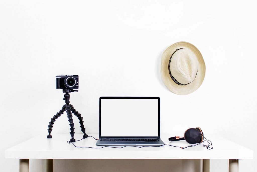vlog camera with headphones and laptop on home work desk
