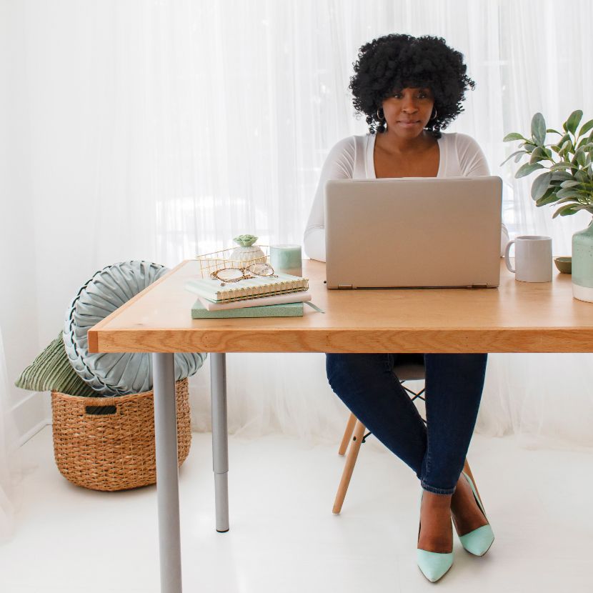 woman sitting at desk using virtual assistant tools in office