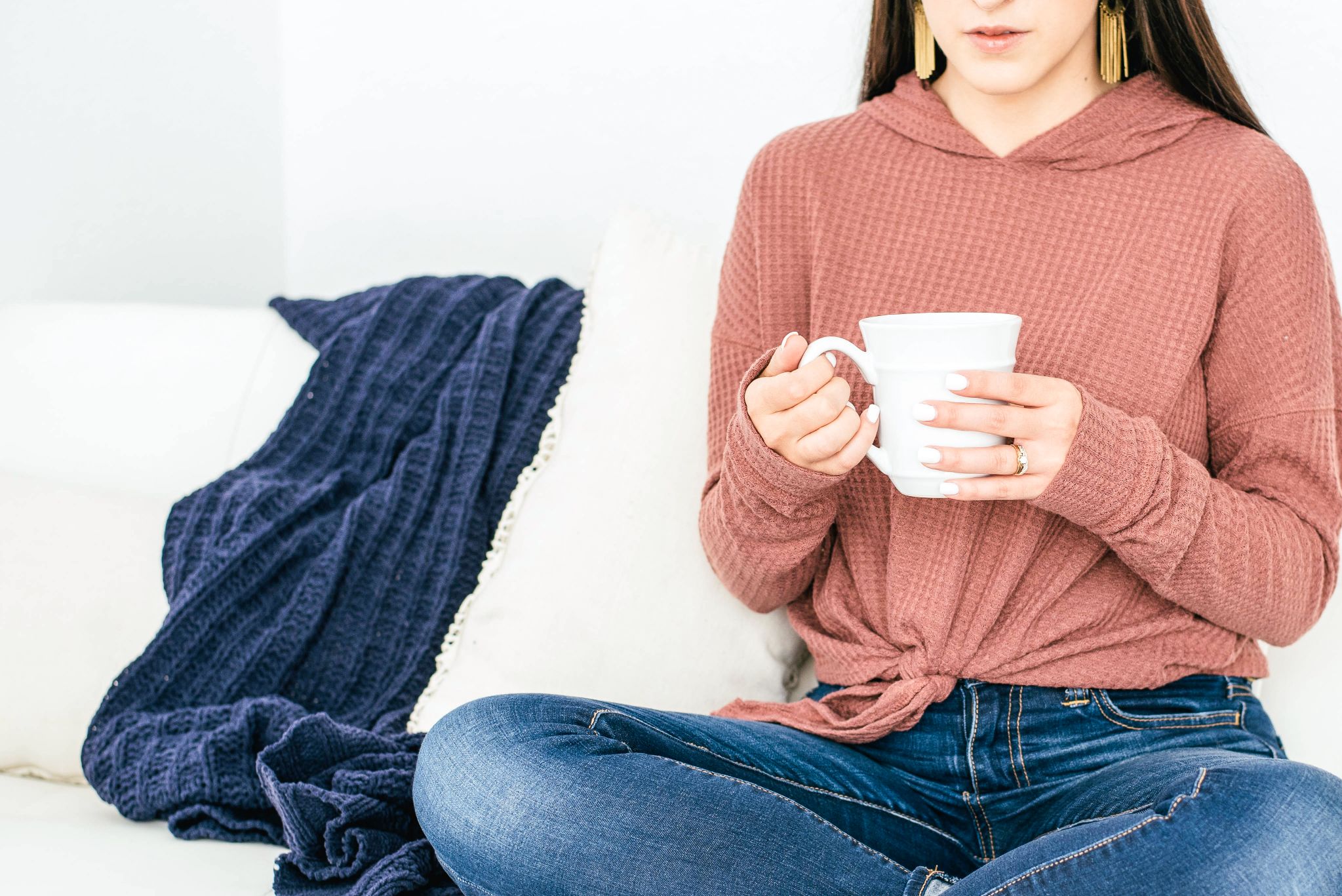 freelancer working from couch virtual assistant with coffee cup on couch