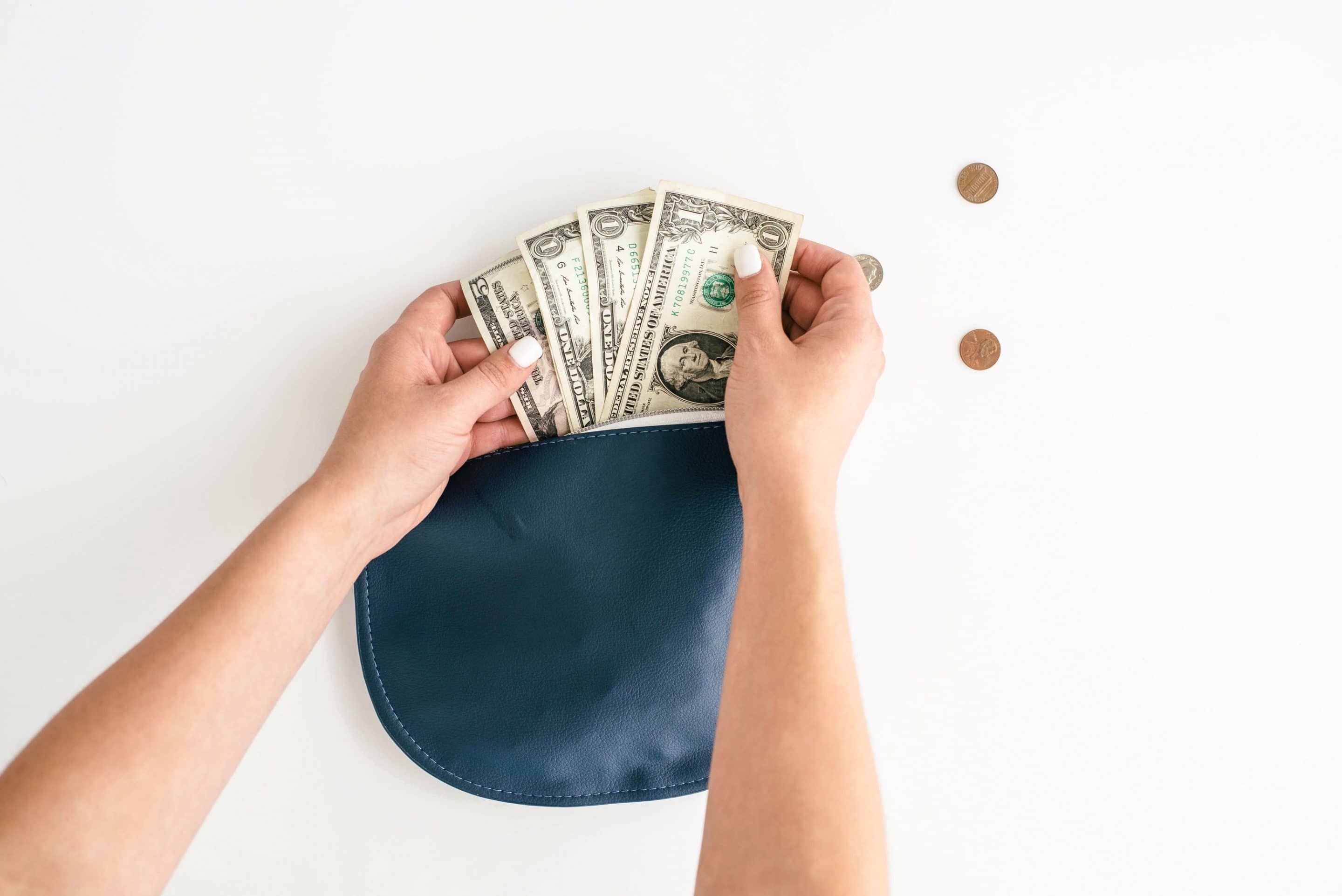 hands pulling cash out of wallet