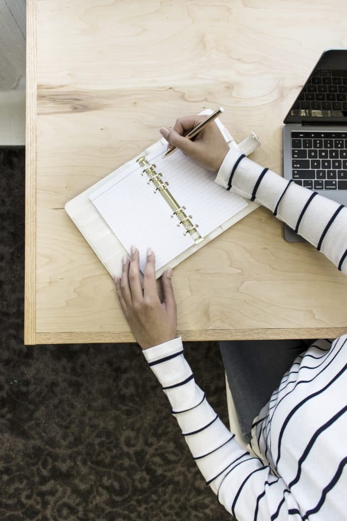 woman writing in day planner