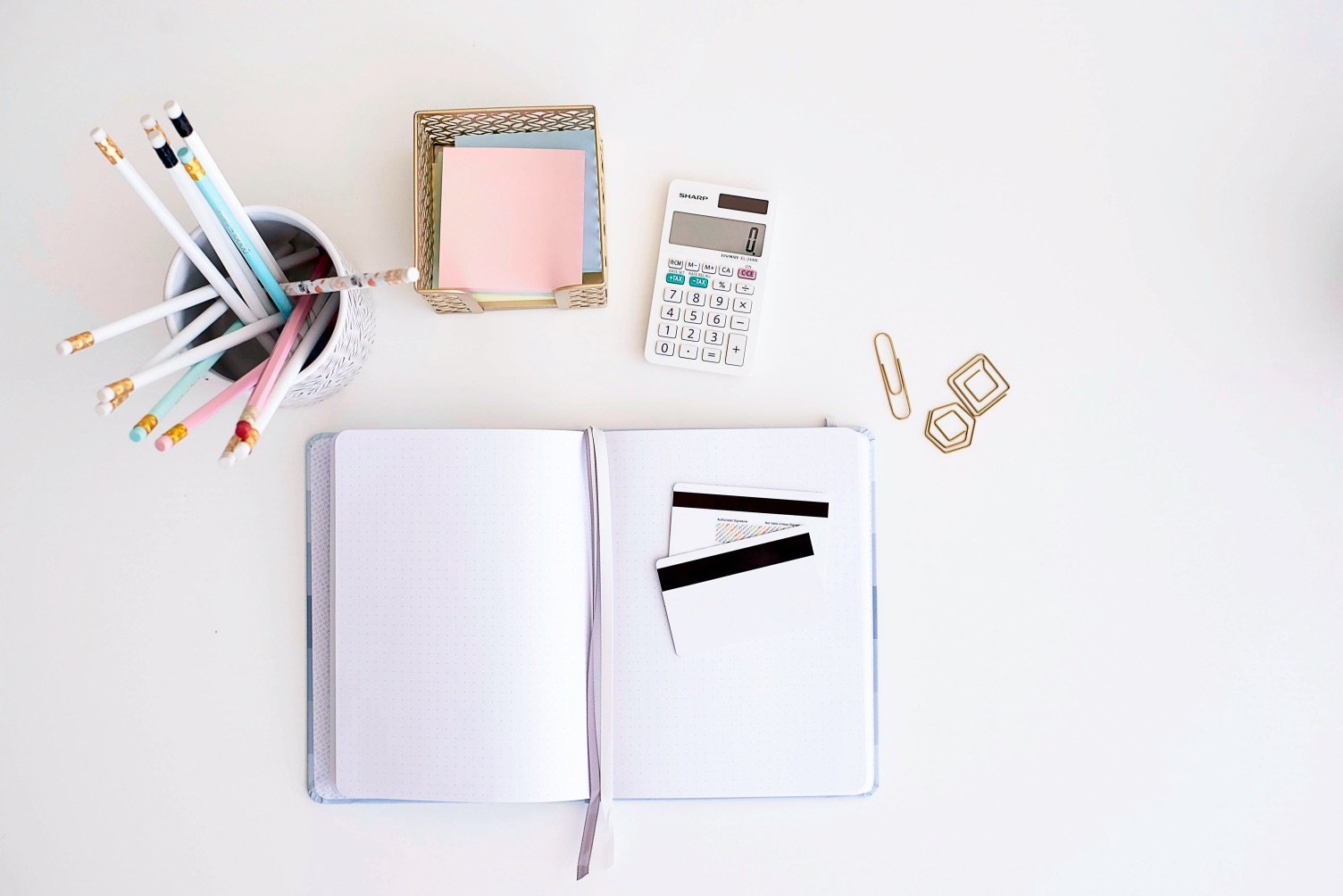 notebook and calculator laying on desk