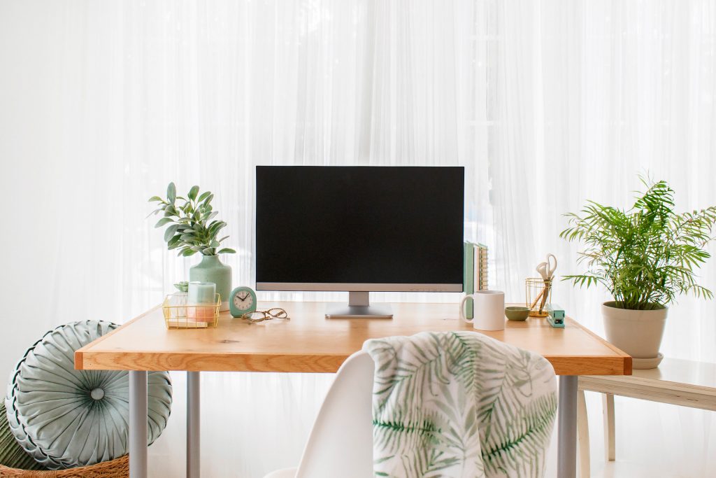 desktop computer and desk with plant