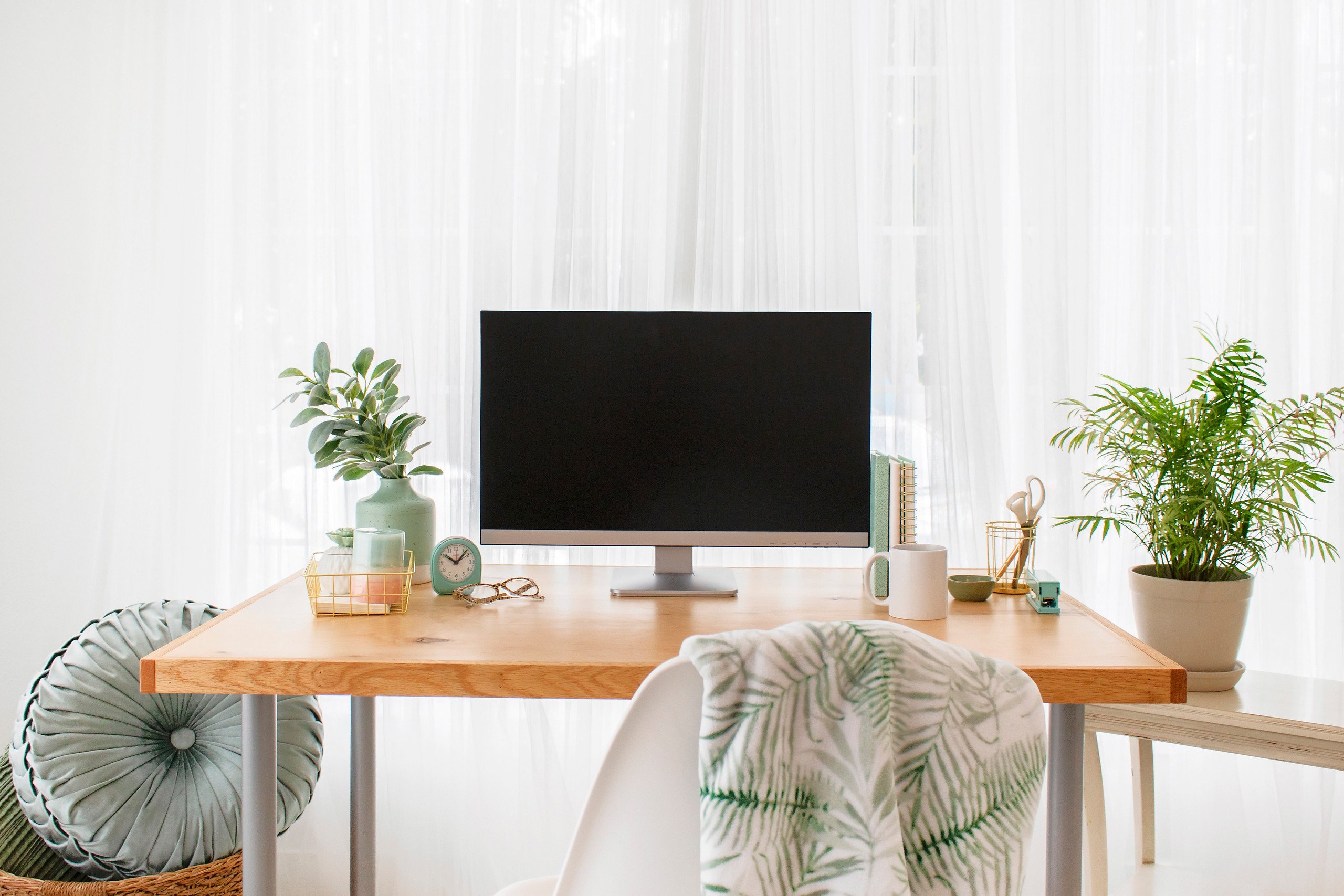 desktop computer and desk with plant