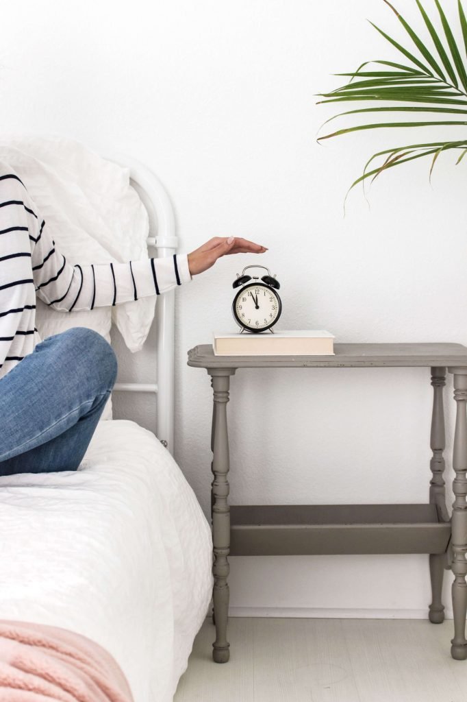 Alarm clock on nightstand next to bed