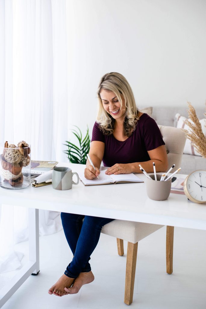 mature woman working at home office desk