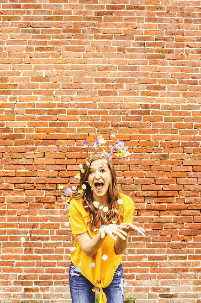 woman throwing confetti to celebrate launch