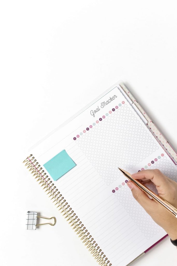 hand writing on goal planner notebook.