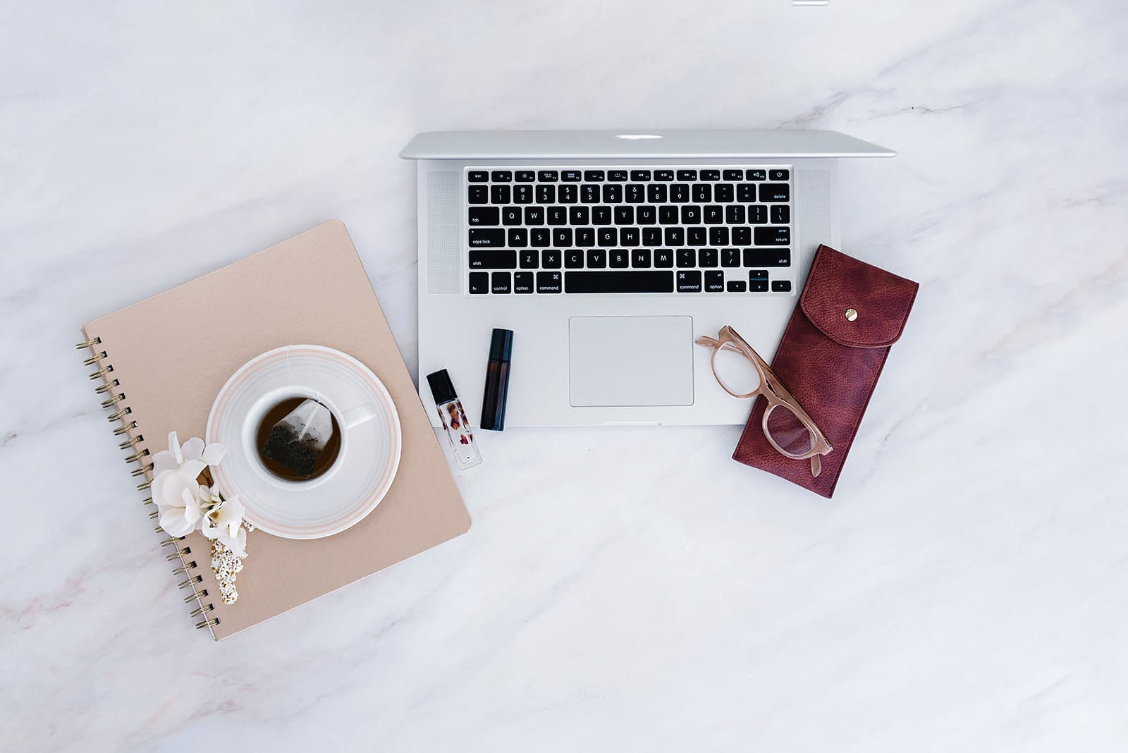 Laptop with coffee mug and notebook