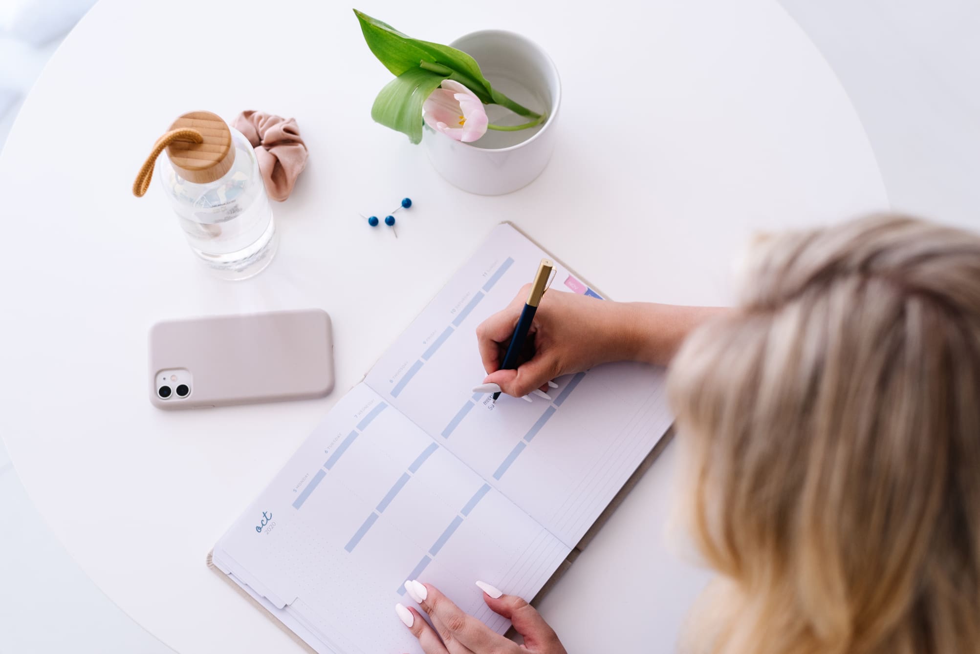 woman planning her schedule in a journal