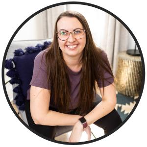 latasha Doyle sitting on a chair and smiling in a purple t-shirt