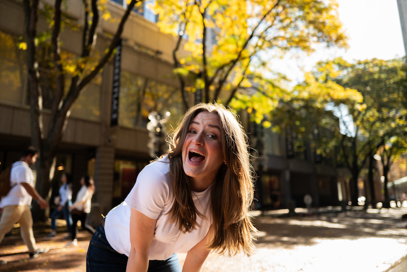 Chynna with excited expression walking in the city