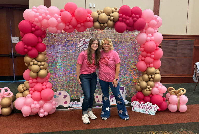 chynna benton and tamara bennett standing in photo booth at southern adoornments decor event