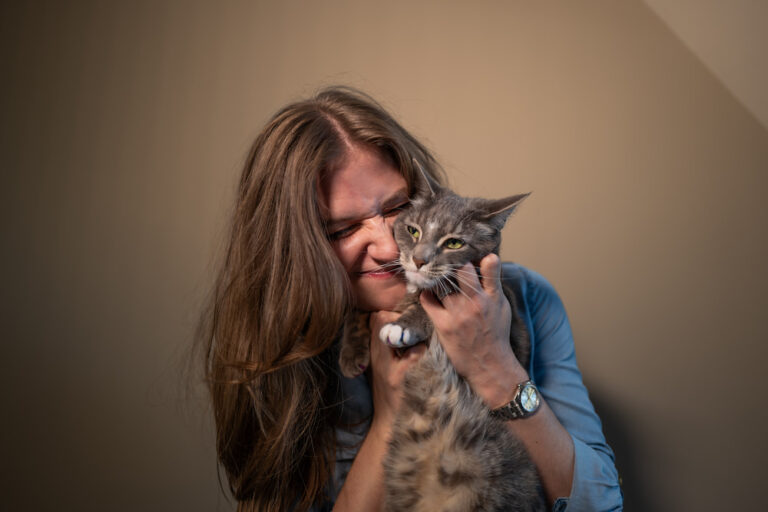 Chynna holding and snuggling her grey tiger cat, Rory