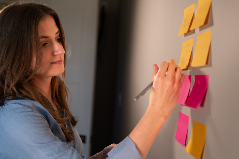 Chynna Benton strategizing with post-its on a wall
